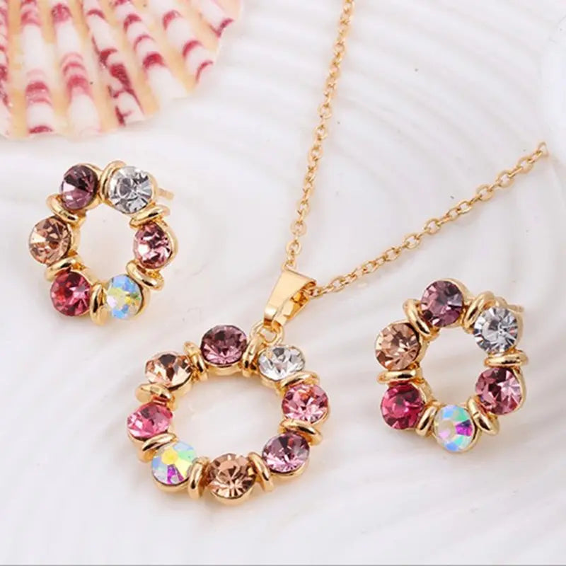 Necklace with circular pendant featuring multicolored gemstones on a white background