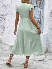 Vestido de verano con escote en V y textura de color sólido fresco y nuevo, muy vendido en Europa y Estados Unidos. 